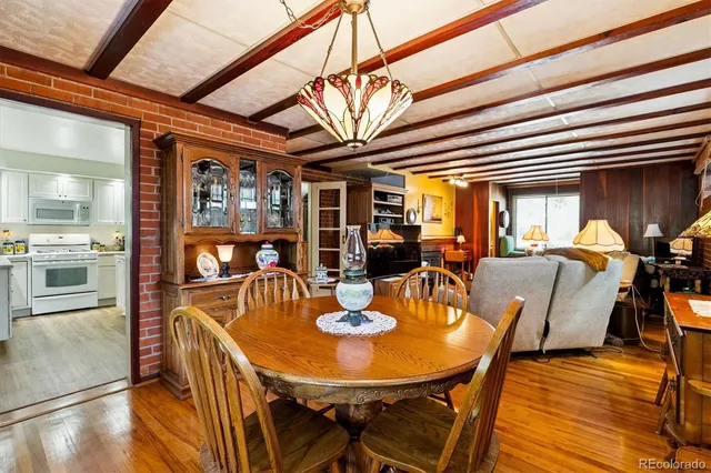 a dining room with furniture a window and wooden floor