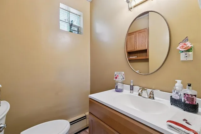 a bathroom with a sink mirror and toilet