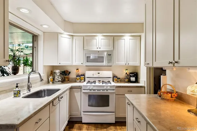 a kitchen with a sink stove and cabinets