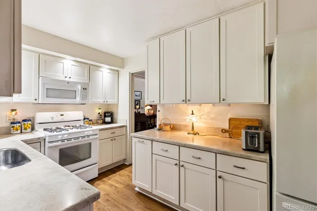 a kitchen with cabinets appliances and a window