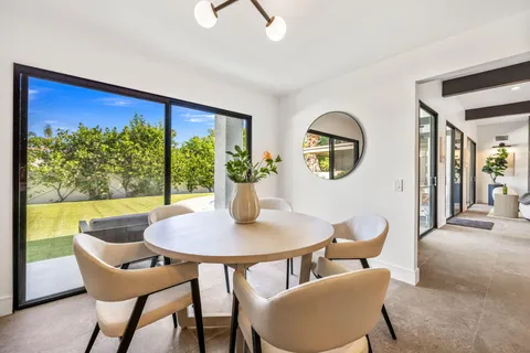 a large kitchen with kitchen island a large window in it