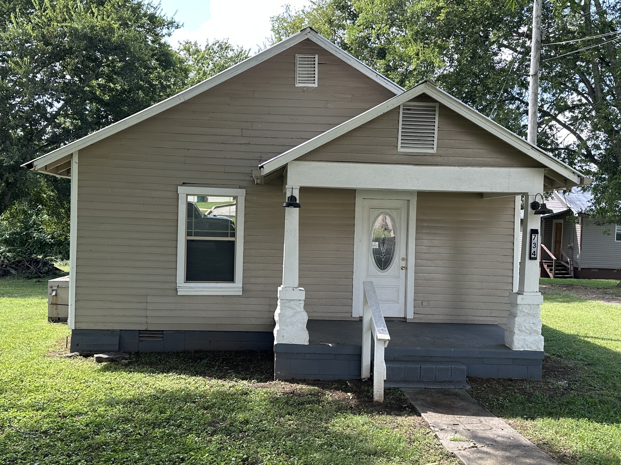 734 Childers Street Pulaski, TN 38478 - Photo 1 of 9 a front view of a house with garden