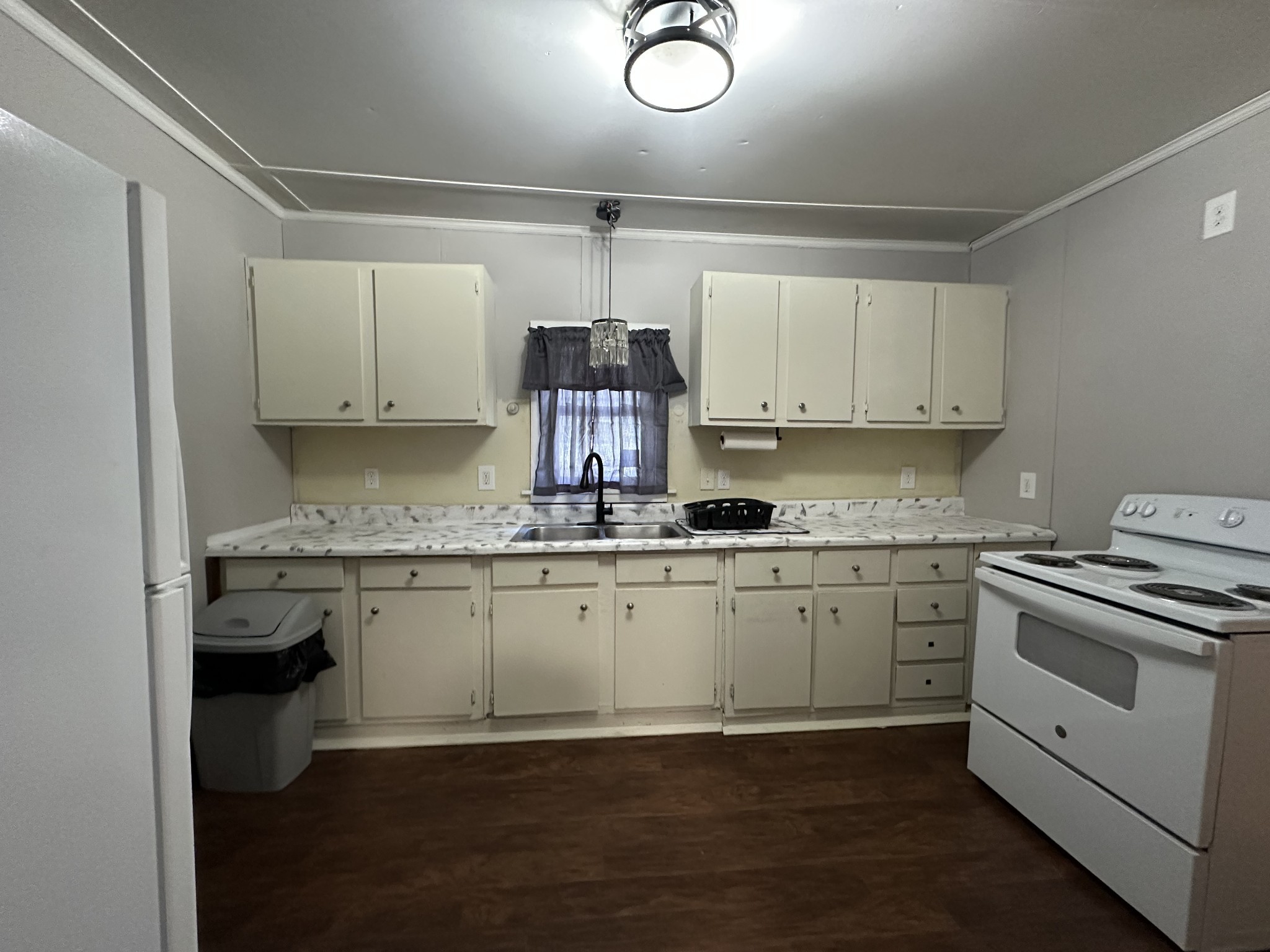 734 Childers Street Pulaski, TN 38478 - Photo 8 of 9 a kitchen with granite countertop white cabinets and white appliances