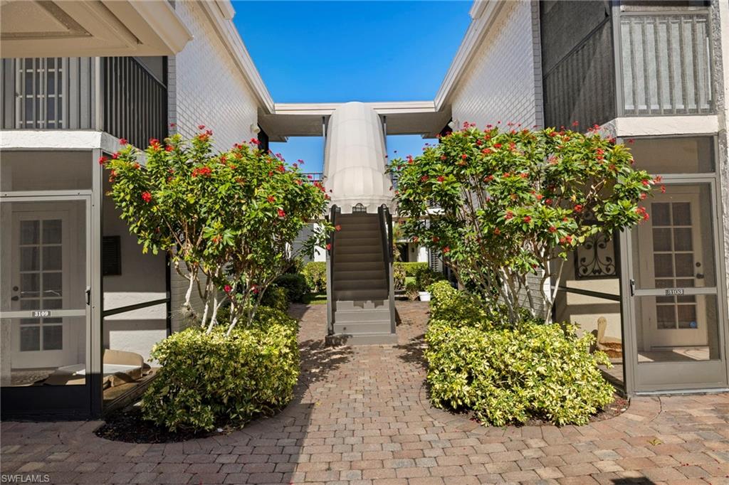 3101 Riviera Drive Naples, FL 34103 - Photo 1 of 41 a front view of a house with garden