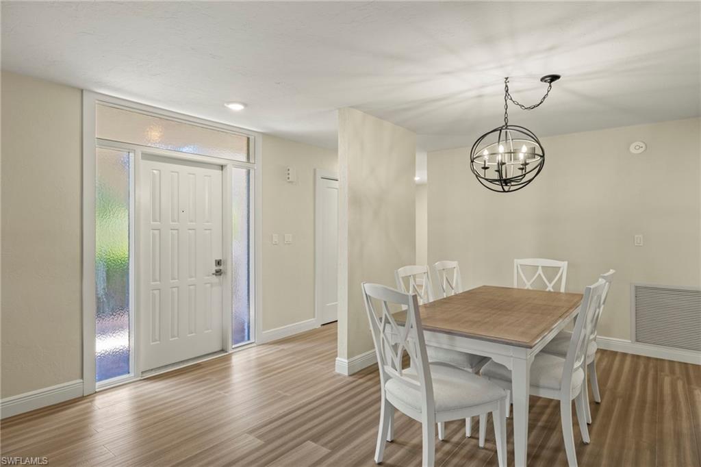 3101 Riviera Drive Naples, FL 34103 - Photo 12 of 41 a view of a dining table and chairs in a room