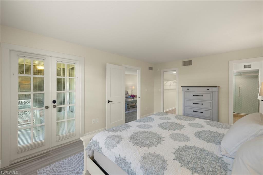3101 Riviera Drive Naples, FL 34103 - Photo 14 of 41 a view of a bedroom with closet and wooden floor