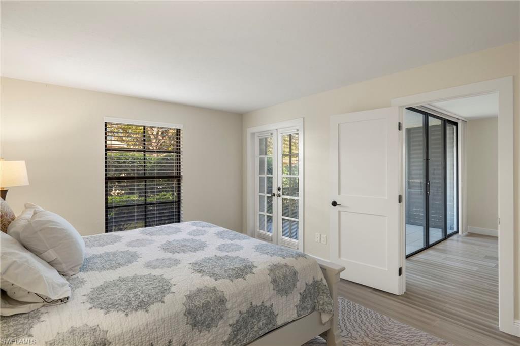 3101 Riviera Drive Naples, FL 34103 - Photo 15 of 41 a bedroom with a large bed and a window