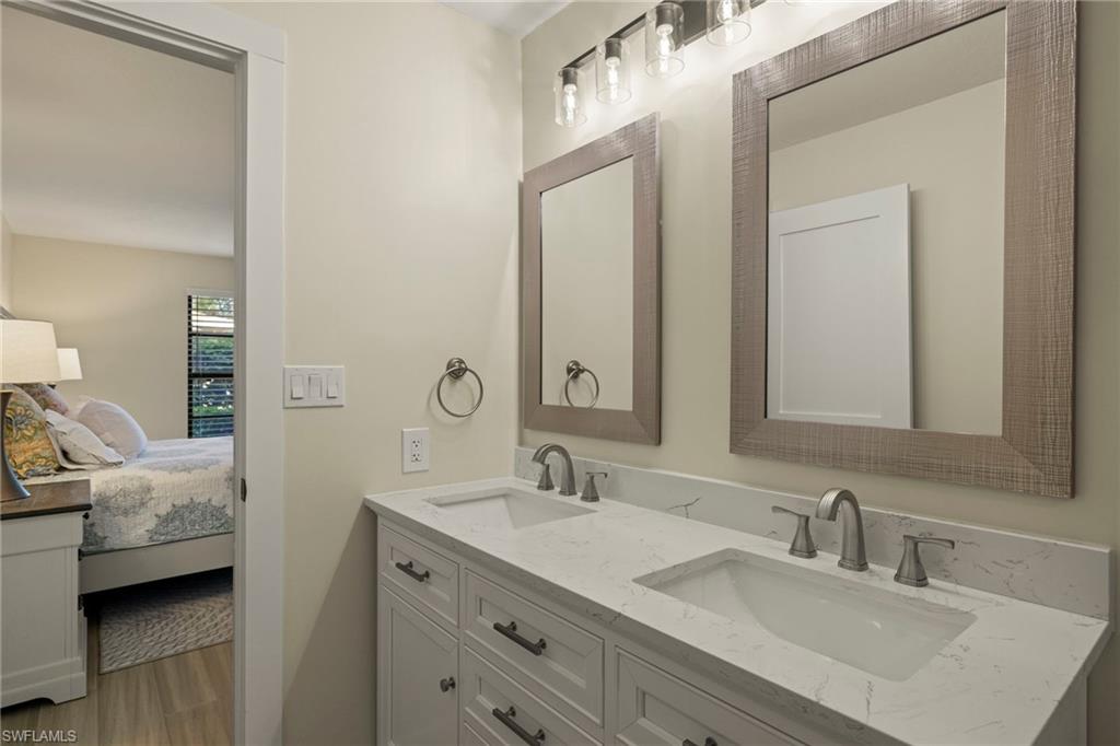 3101 Riviera Drive Naples, FL 34103 - Photo 16 of 41 a en suite bathroom with a double vanity sink and a mirror