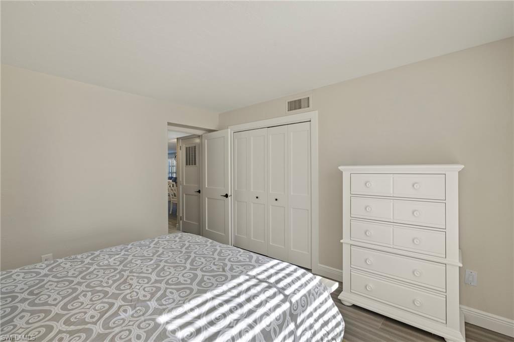 3101 Riviera Drive Naples, FL 34103 - Photo 18 of 41 a bedroom with a bed and a dresser