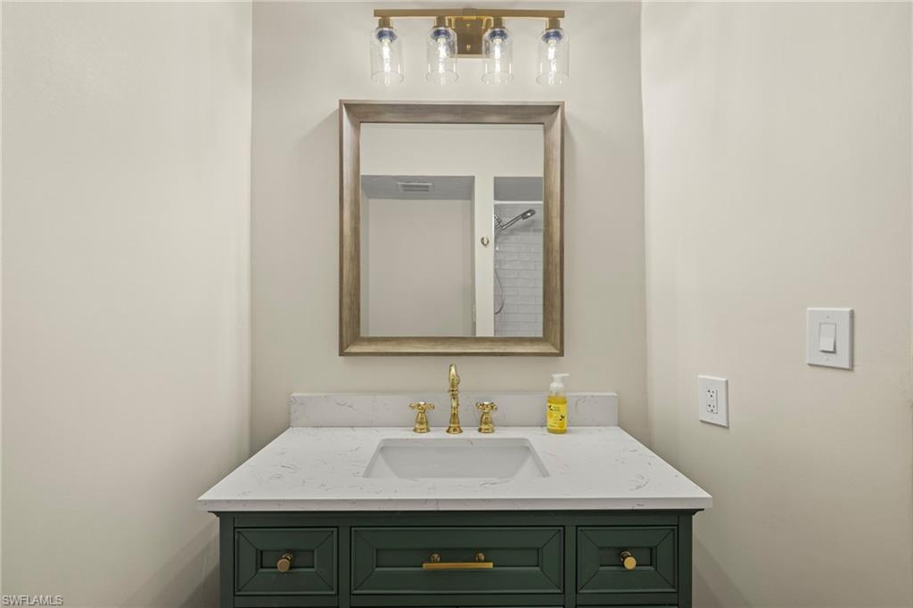 3101 Riviera Drive Naples, FL 34103 - Photo 19 of 41 a bathroom with a sink and a mirror