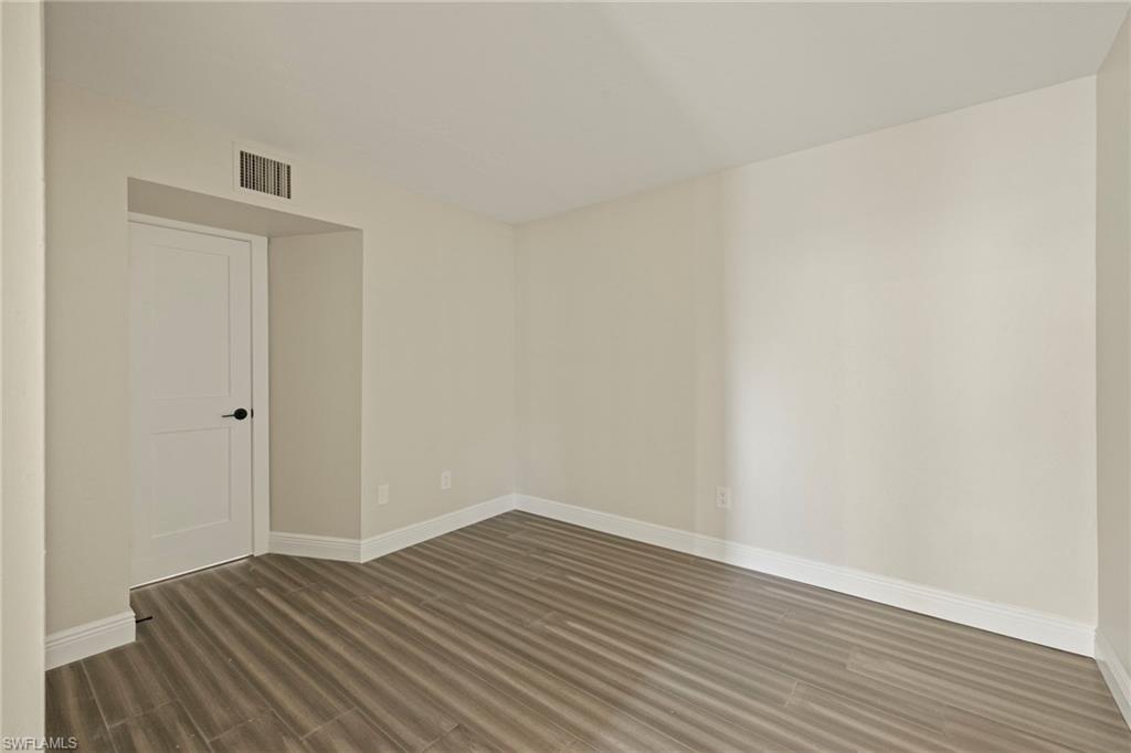 3101 Riviera Drive Naples, FL 34103 - Photo 20 of 41 a view of wooden floor and windows in a room