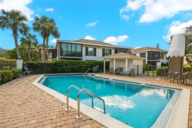 a view of a house with swimming pool and sitting area