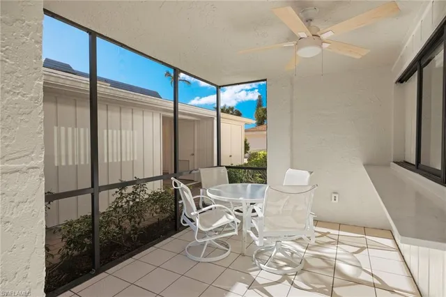 a view of a livingroom with furniture and a floor to ceiling window