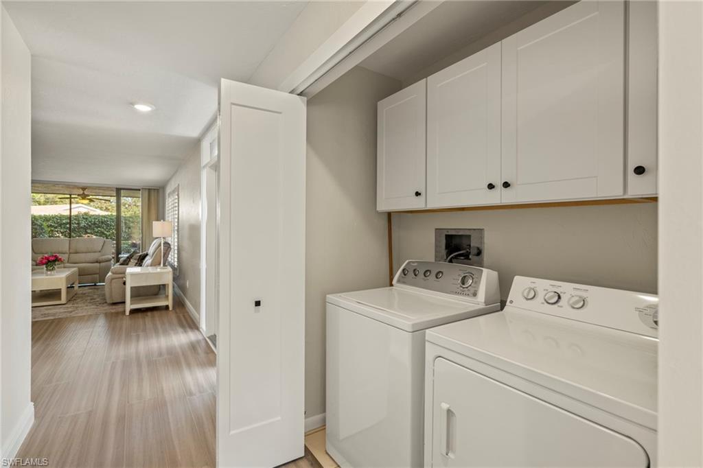 3101 Riviera Drive Naples, FL 34103 - Photo 23 of 41 a view of washer and dryer with wooden floor