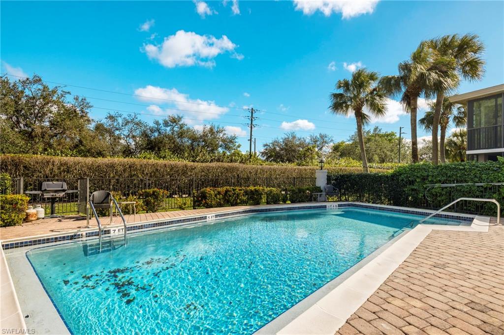 3101 Riviera Drive Naples, FL 34103 - Photo 24 of 41 a view of a swimming pool with a patio