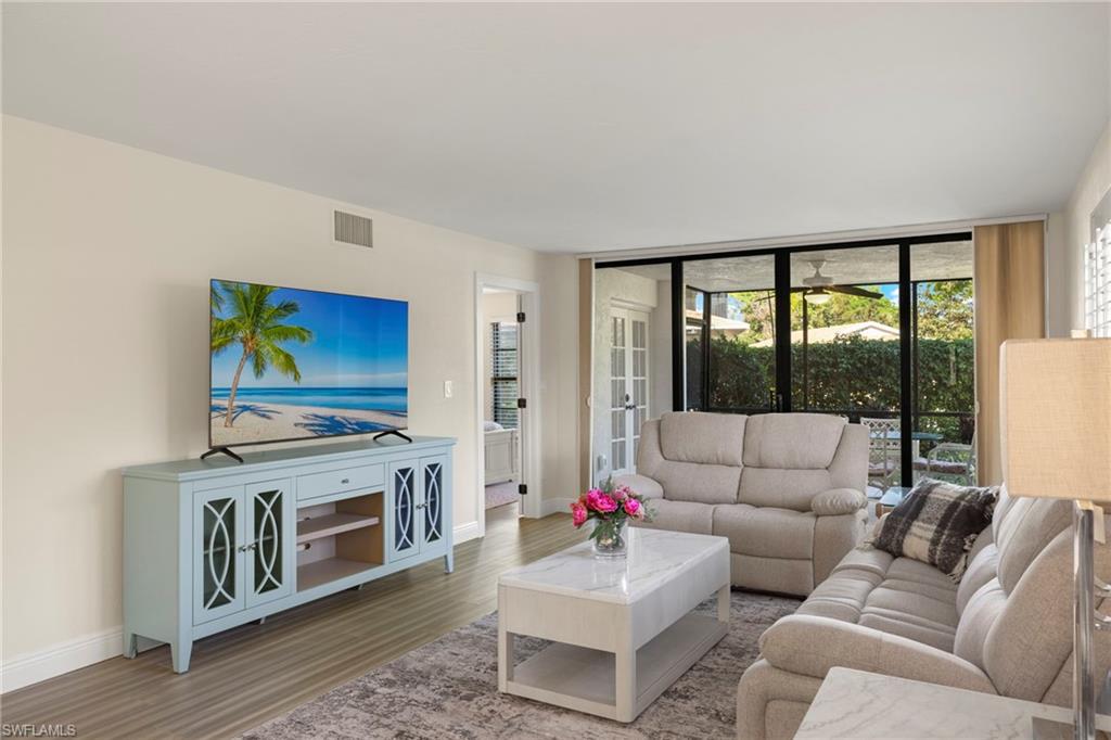 3101 Riviera Drive Naples, FL 34103 - Photo 4 of 41 a living room with furniture fireplace and flat screen tv