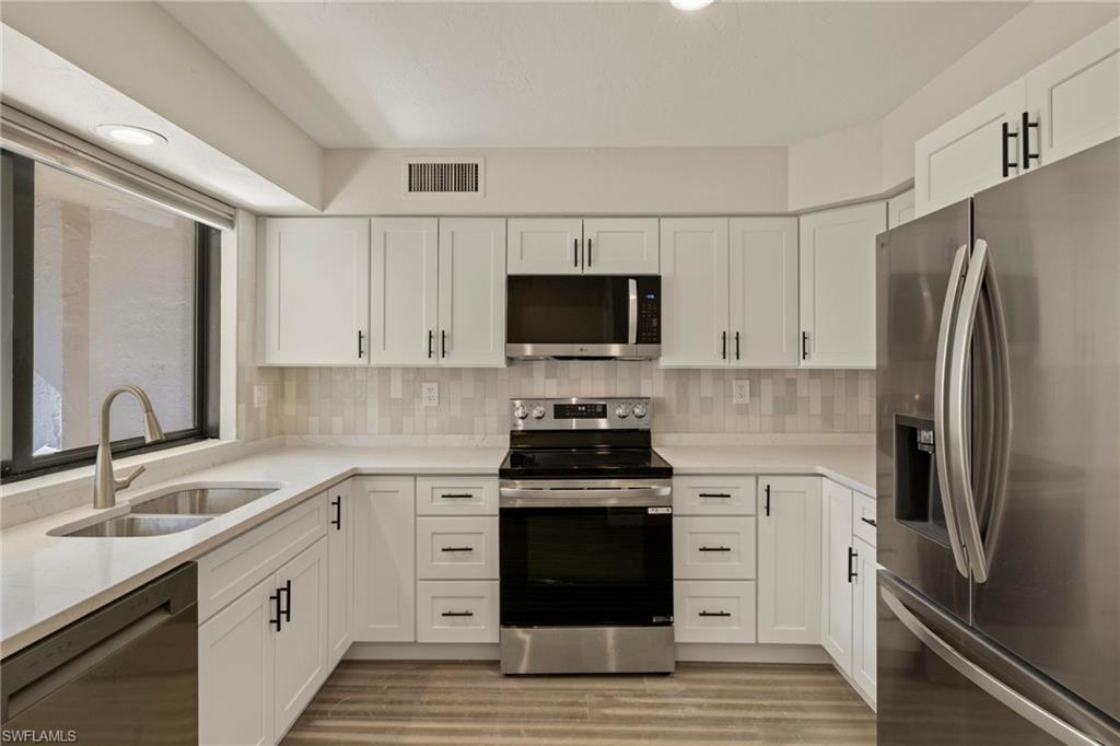 3101 Riviera Drive Naples, FL 34103 - Photo 7 of 41 a kitchen with a sink stove and refrigerator
