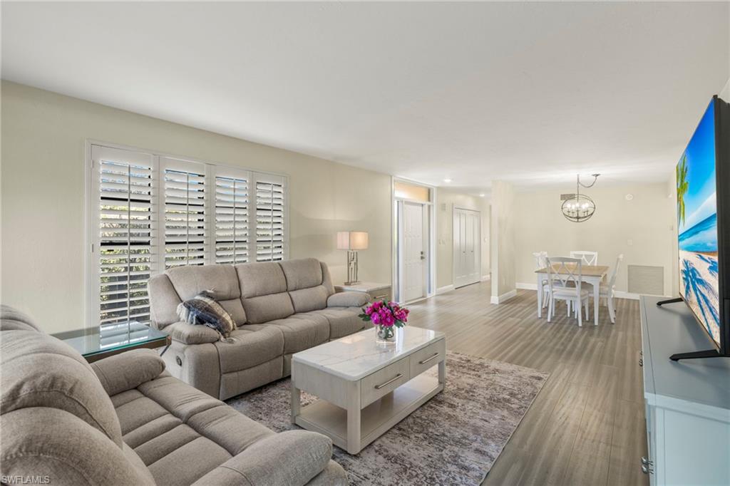3101 Riviera Drive Naples, FL 34103 - Photo 10 of 41 a living room with furniture and a large window