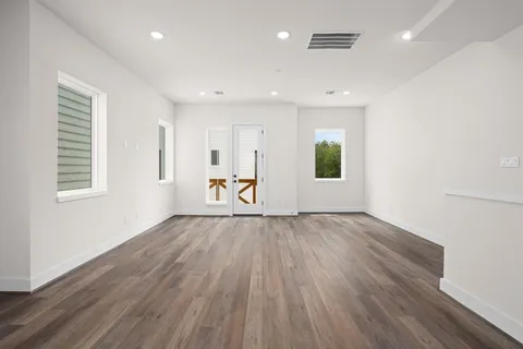 a kitchen with stainless steel appliances granite countertop a sink stove and wooden floor