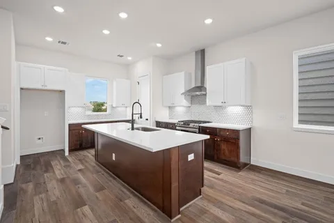 a bathroom with a toilet sink vanity and mirror