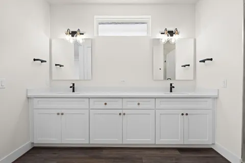 a view of a hallway with wooden floor and closet