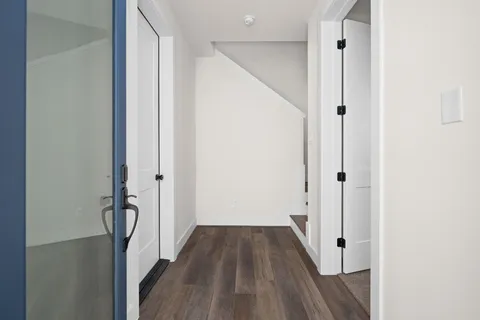 a bathroom with a toilet a sink a mirror and shower