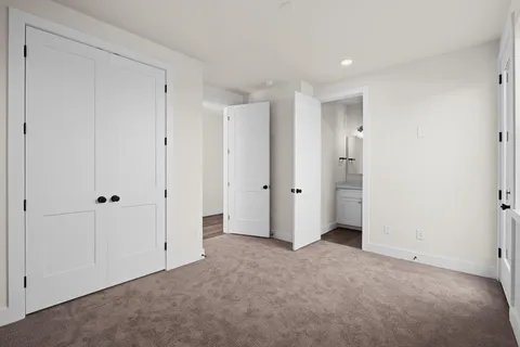 a view of a big room with wooden floor and windows