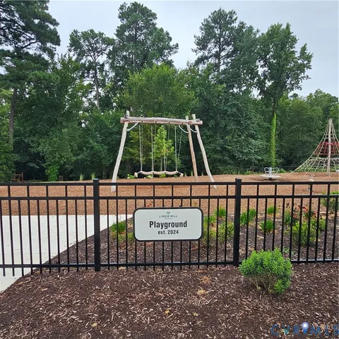 a view of a bench with iron fence