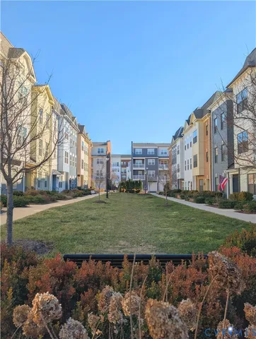 a view of a big building with a big yard and large trees