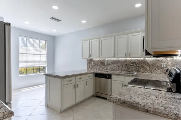 a kitchen with a sink stove and cabinets