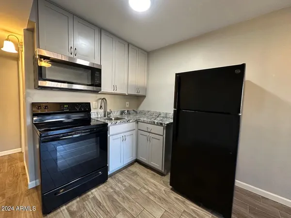 a kitchen with a refrigerator stove and microwave