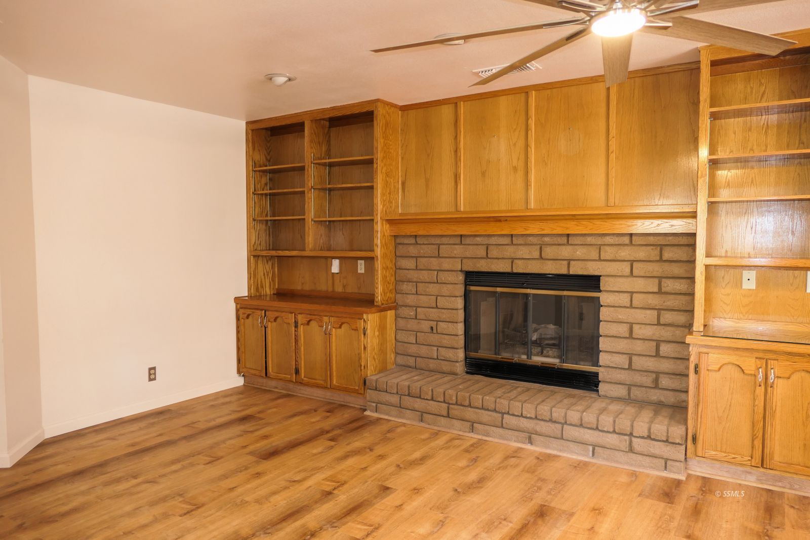 925 Hermosa Avenue Ridgecrest, CA 93555 - Photo 9 of 50 a view of an empty room with a fireplace and a window