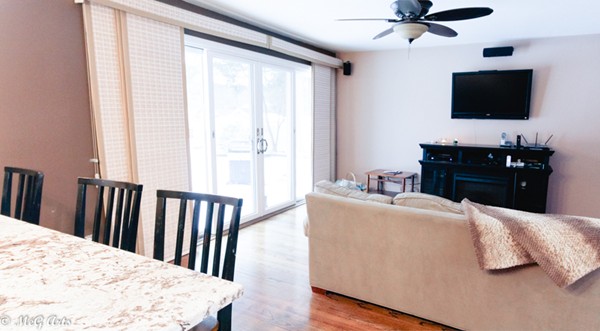 55 Lindsay Road Springfield, MA 01128 - Photo 7 of 18 a living room with a bed and a flat screen tv