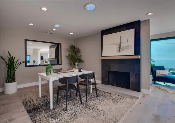 a living room with a fireplace dining table and a fireplace
