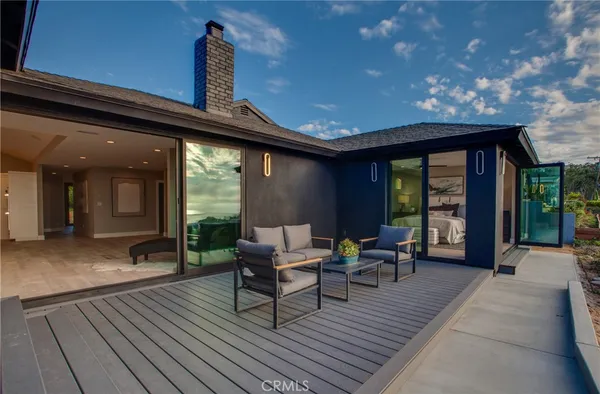 a view of a patio with furniture and floor to ceiling window