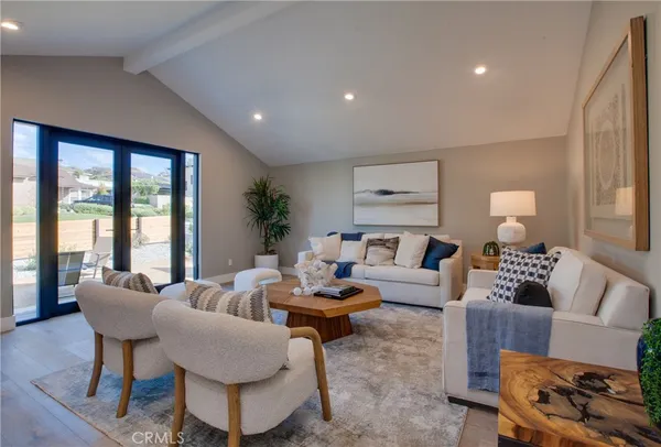 a living room with furniture and large windows