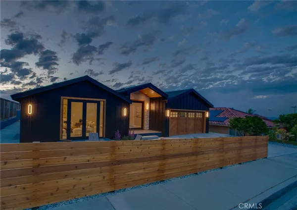 a view of house with backyard and outdoor seating