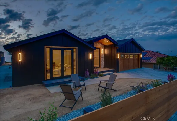 a view of backyard with a patio and outdoor seating