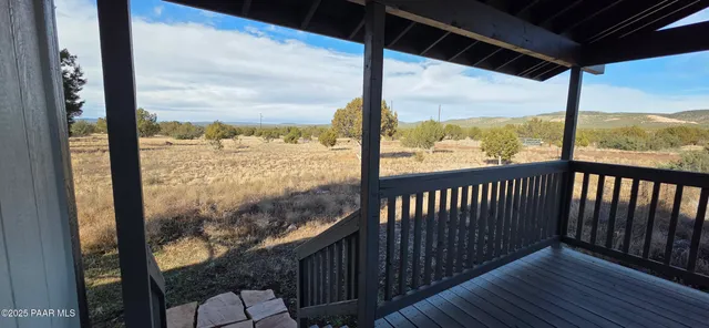a view of a balcony with wooden floor