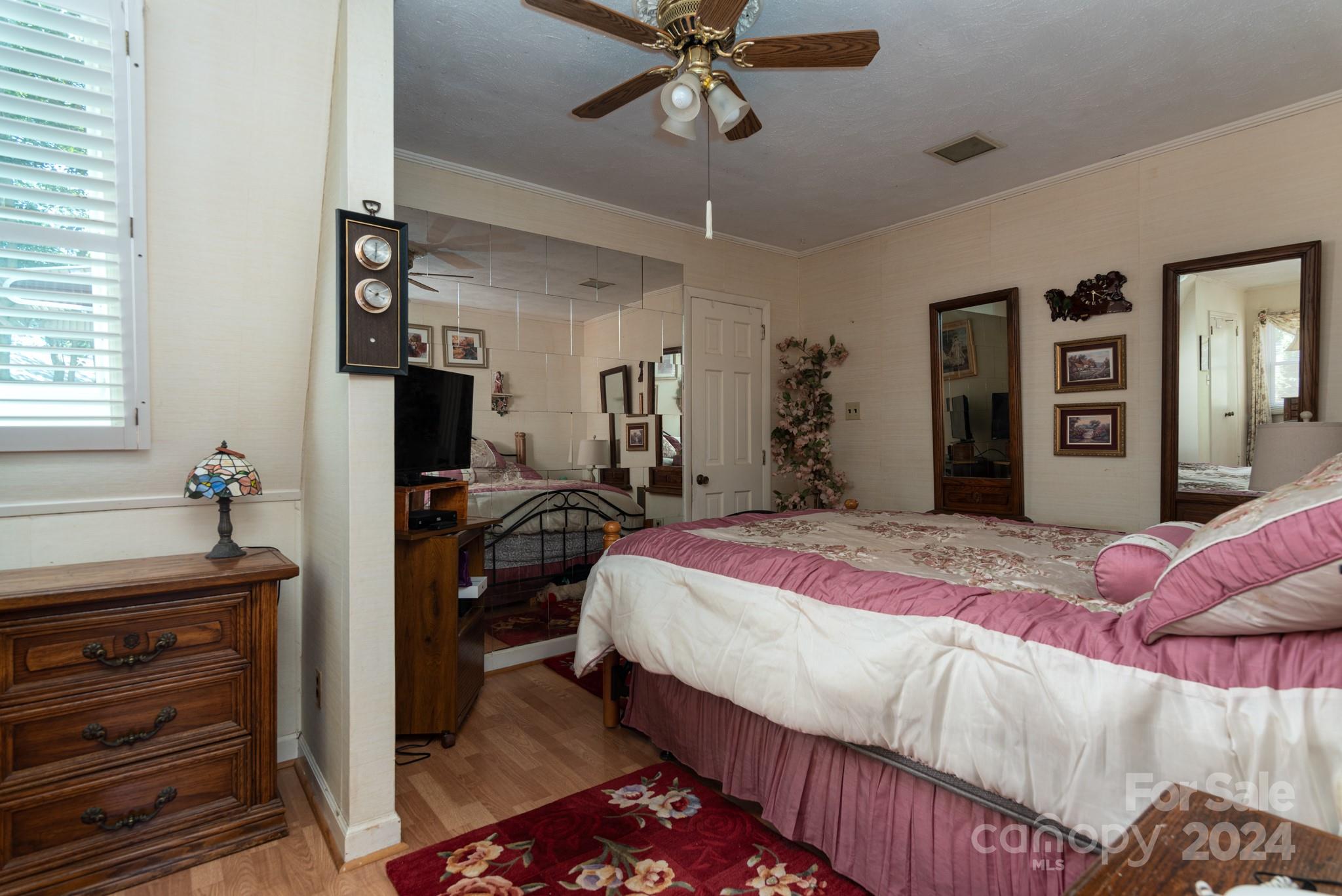 2726 Lake Shore Road South Denver, NC 28037 - Photo 13 of 48 a bedroom with a bed and a chandelier