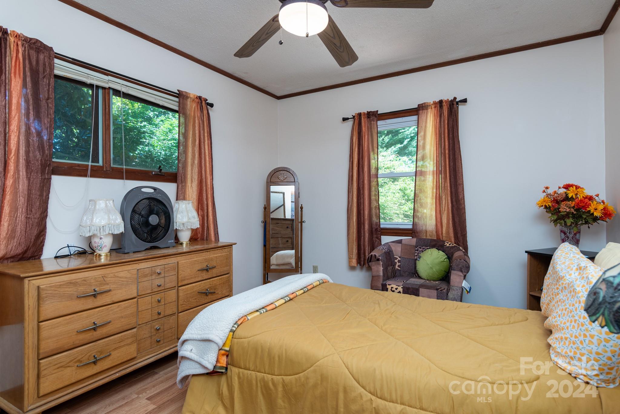 2726 Lake Shore Road South Denver, NC 28037 - Photo 17 of 48 a bedroom with a bed and large windows