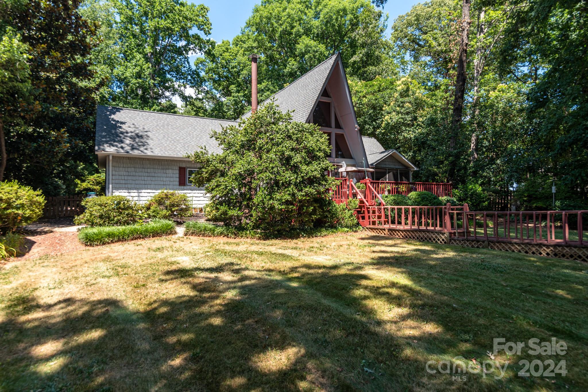 2726 Lake Shore Road South Denver, NC 28037 - Photo 43 of 48 a view of a yard with plants and large trees