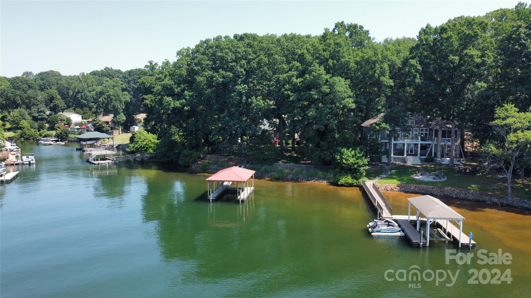 2726 Lake Shore Road South Denver, NC 28037 - Photo 47 of 48 a view of a lake with lawn chairs and a yard