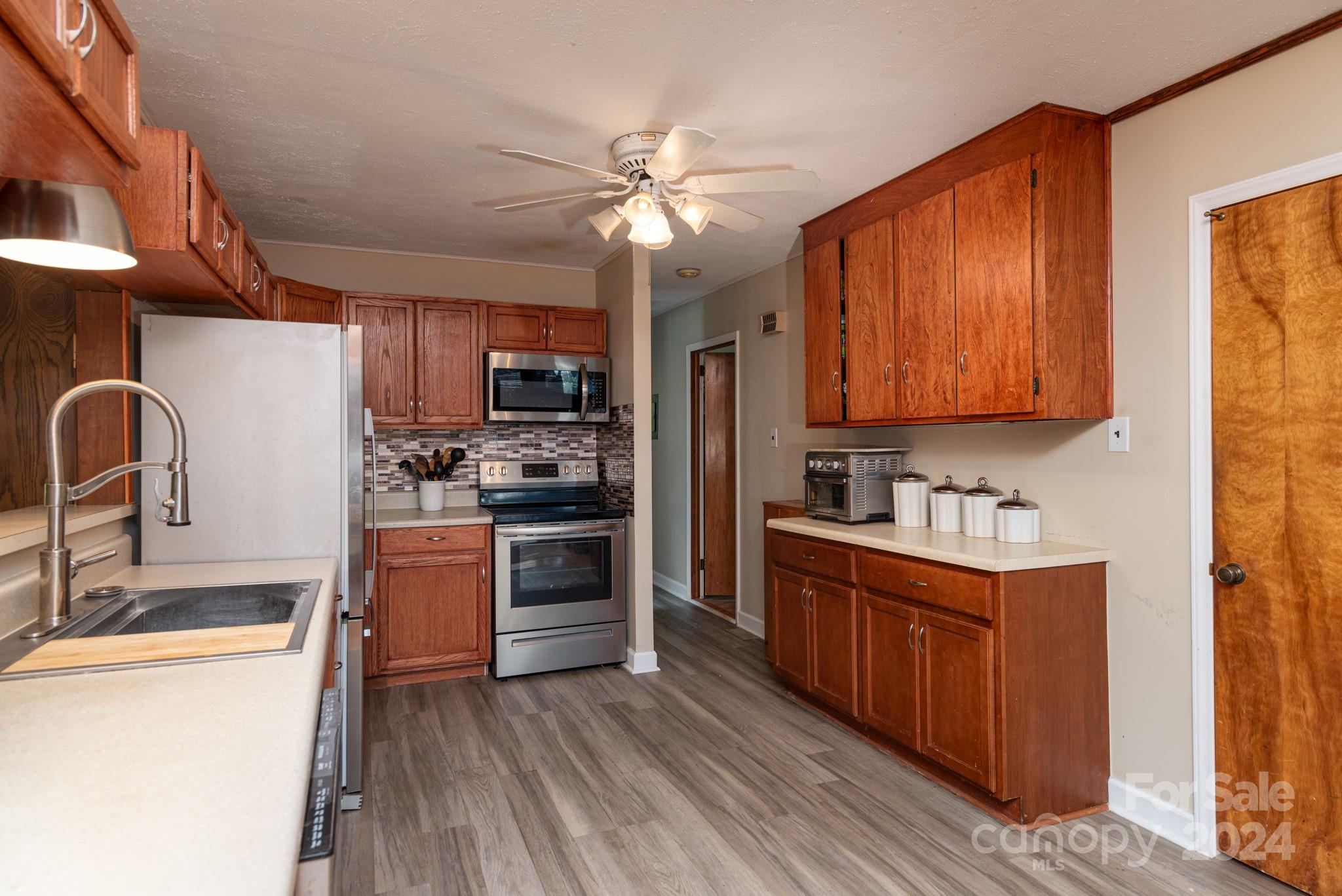 2726 Lake Shore Road South Denver, NC 28037 - Photo 10 of 48 a kitchen with stainless steel appliances granite countertop a stove refrigerator sink and dishwasher with wooden floor