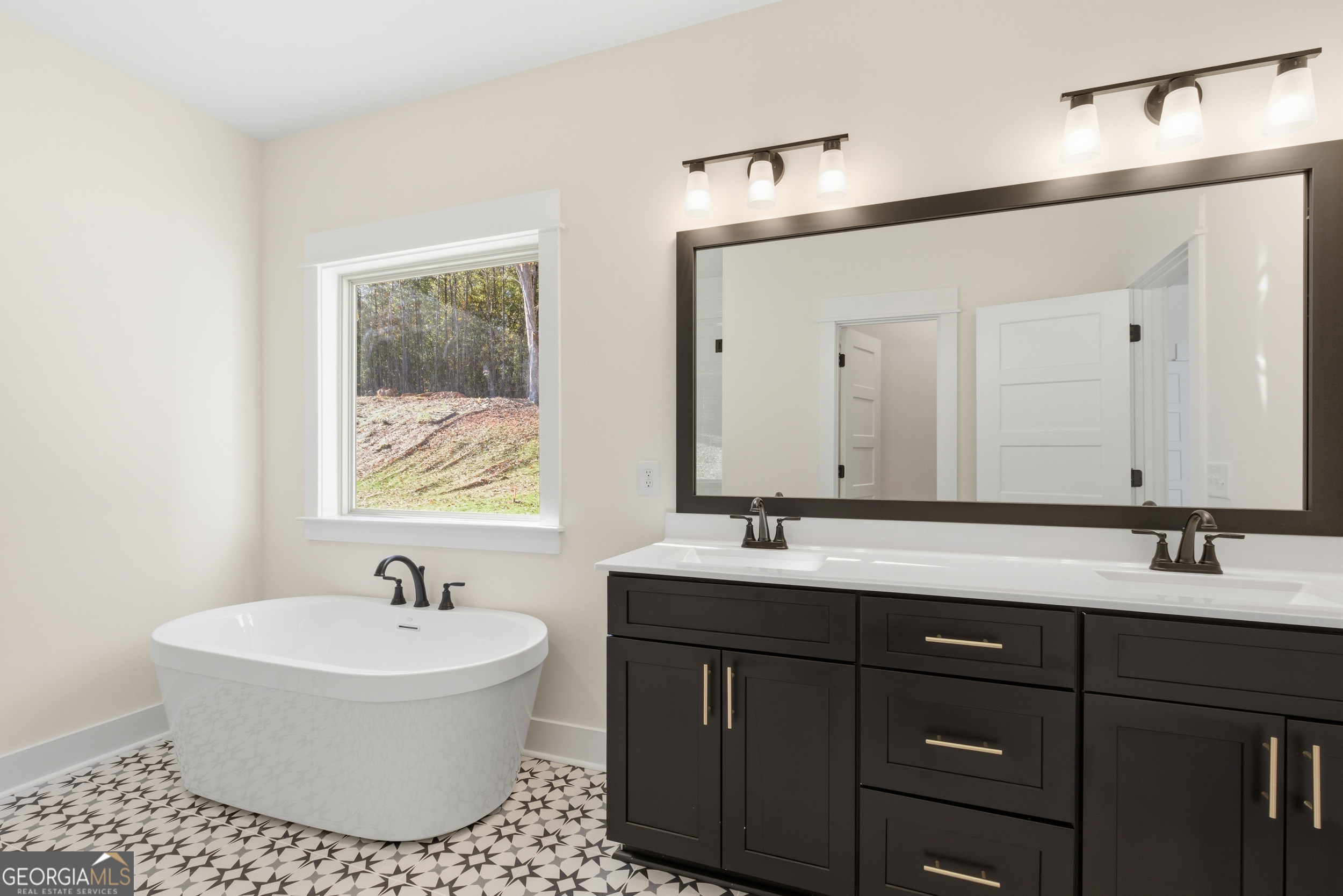 405 Ayers Creek Drive Toccoa, GA 30577 - Photo 17 of 35 a bathroom with a tub sink double vanity and mirror