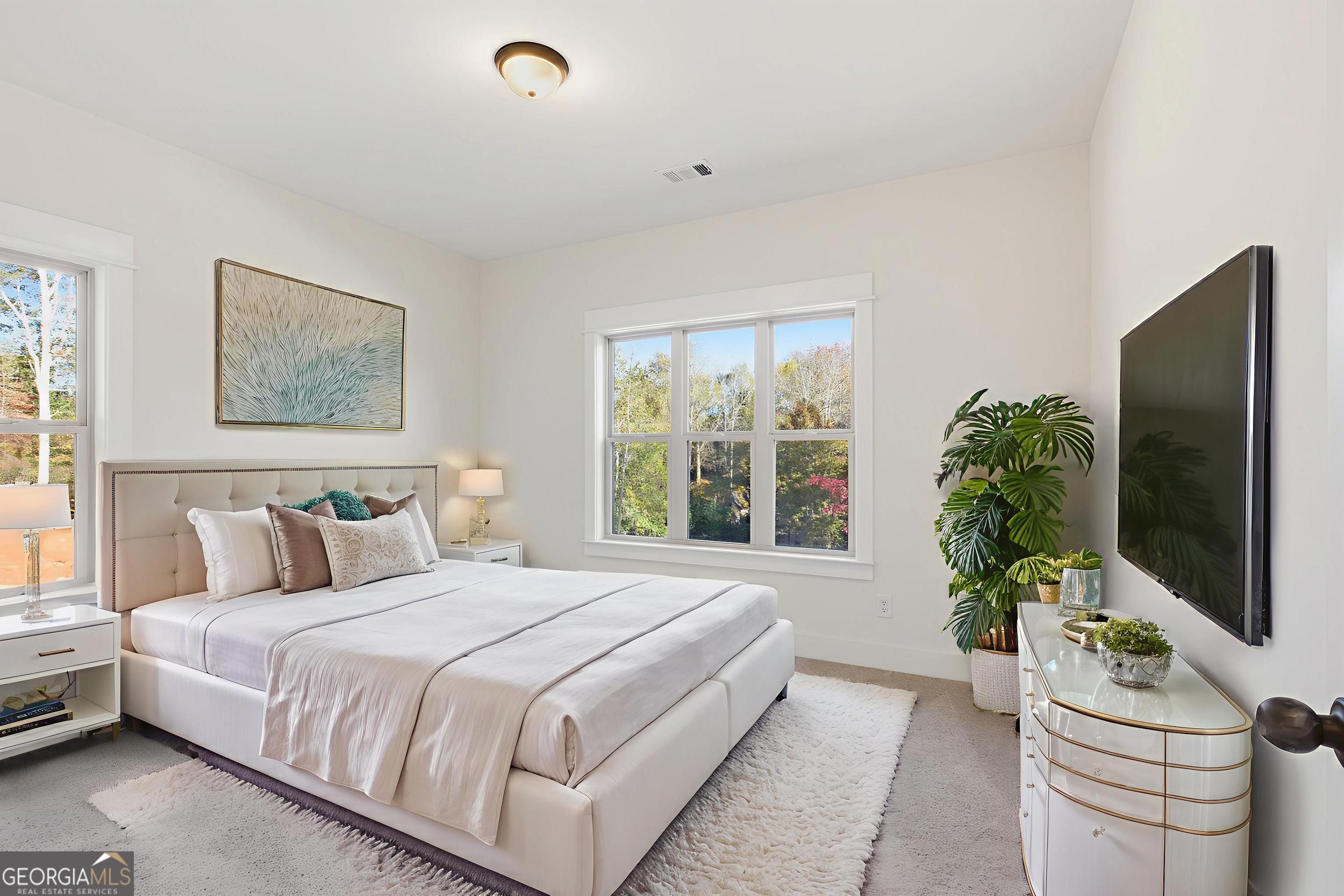 405 Ayers Creek Drive Toccoa, GA 30577 - Photo 22 of 35 a bedroom with a bed and a flat screen tv