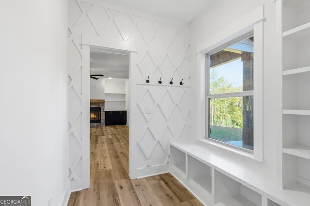 a view of a room with wooden floor and windows