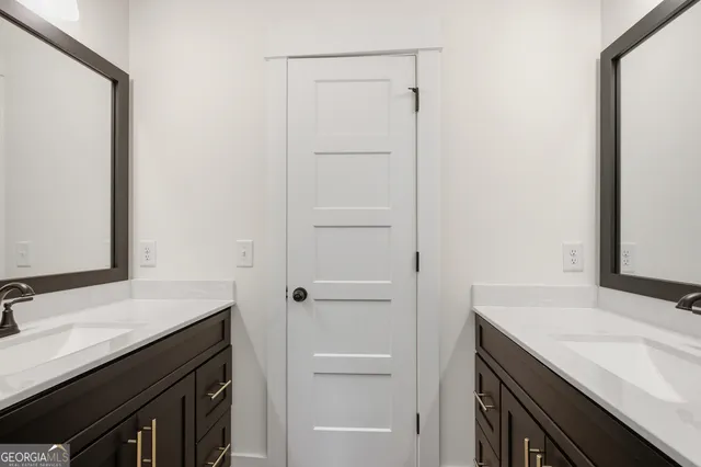 a view of walk in closet with wooden floor