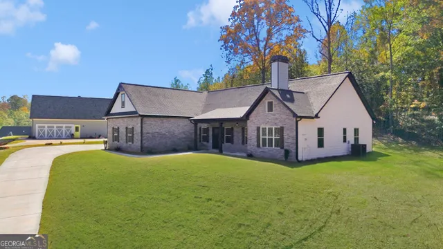 a view of a house with pool and a yard