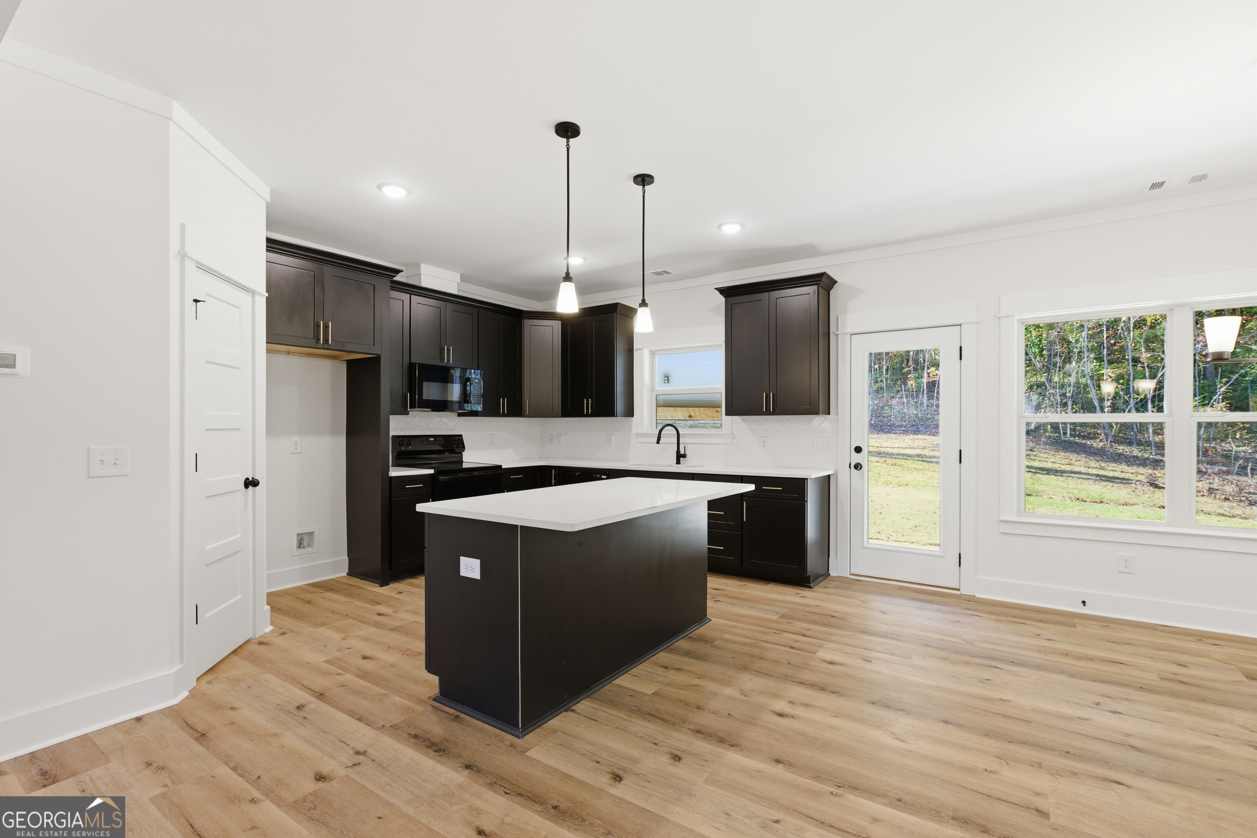 405 Ayers Creek Drive Toccoa, GA 30577 - Photo 10 of 35 a large kitchen with stainless steel appliances kitchen island a large counter top and a wooden floors